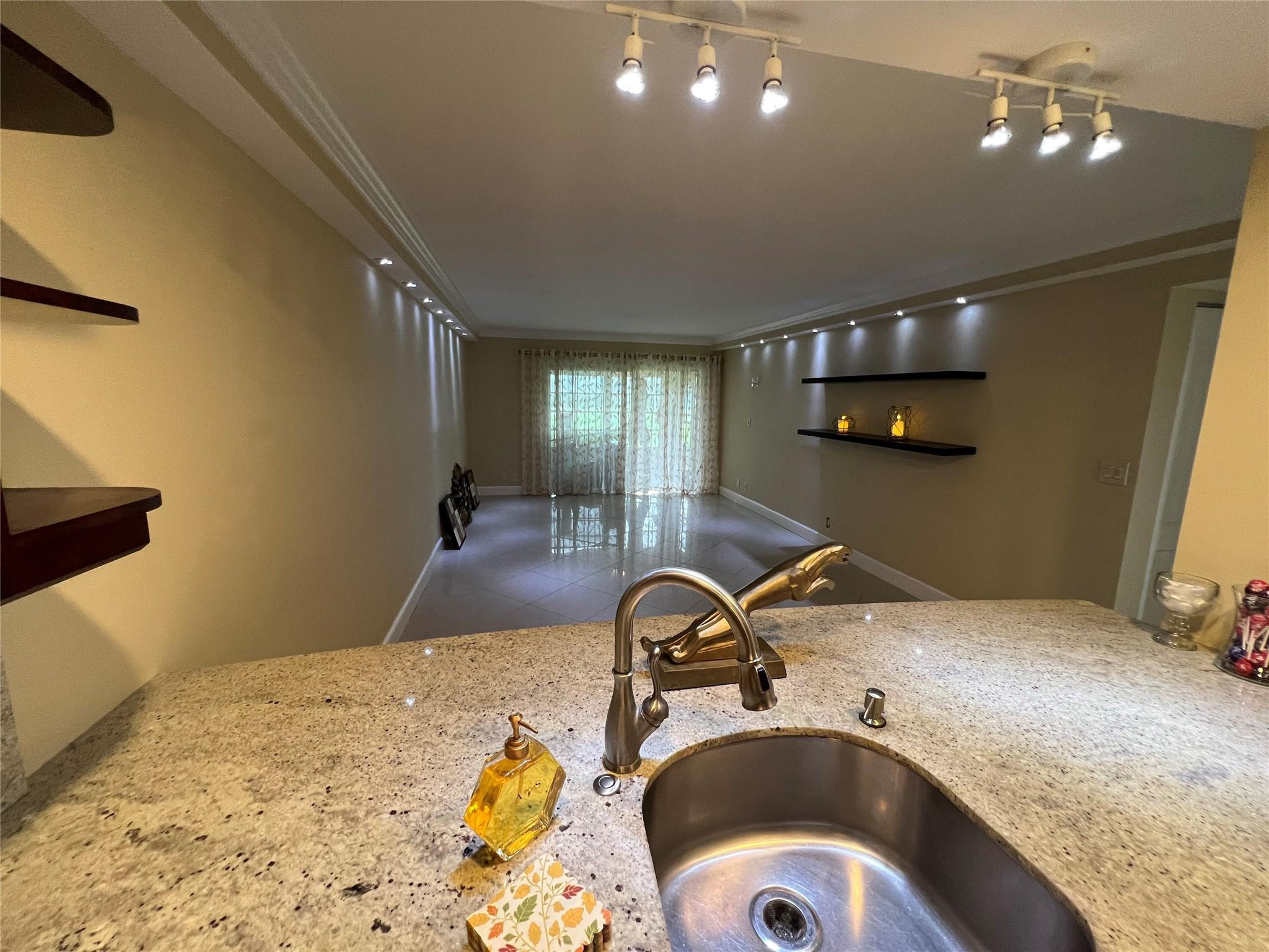 9300 Southwest 8th Street, Unit 108 Boca Raton, FL 33428 - Photo 29 of 40 a bedroom with a sink and a bed