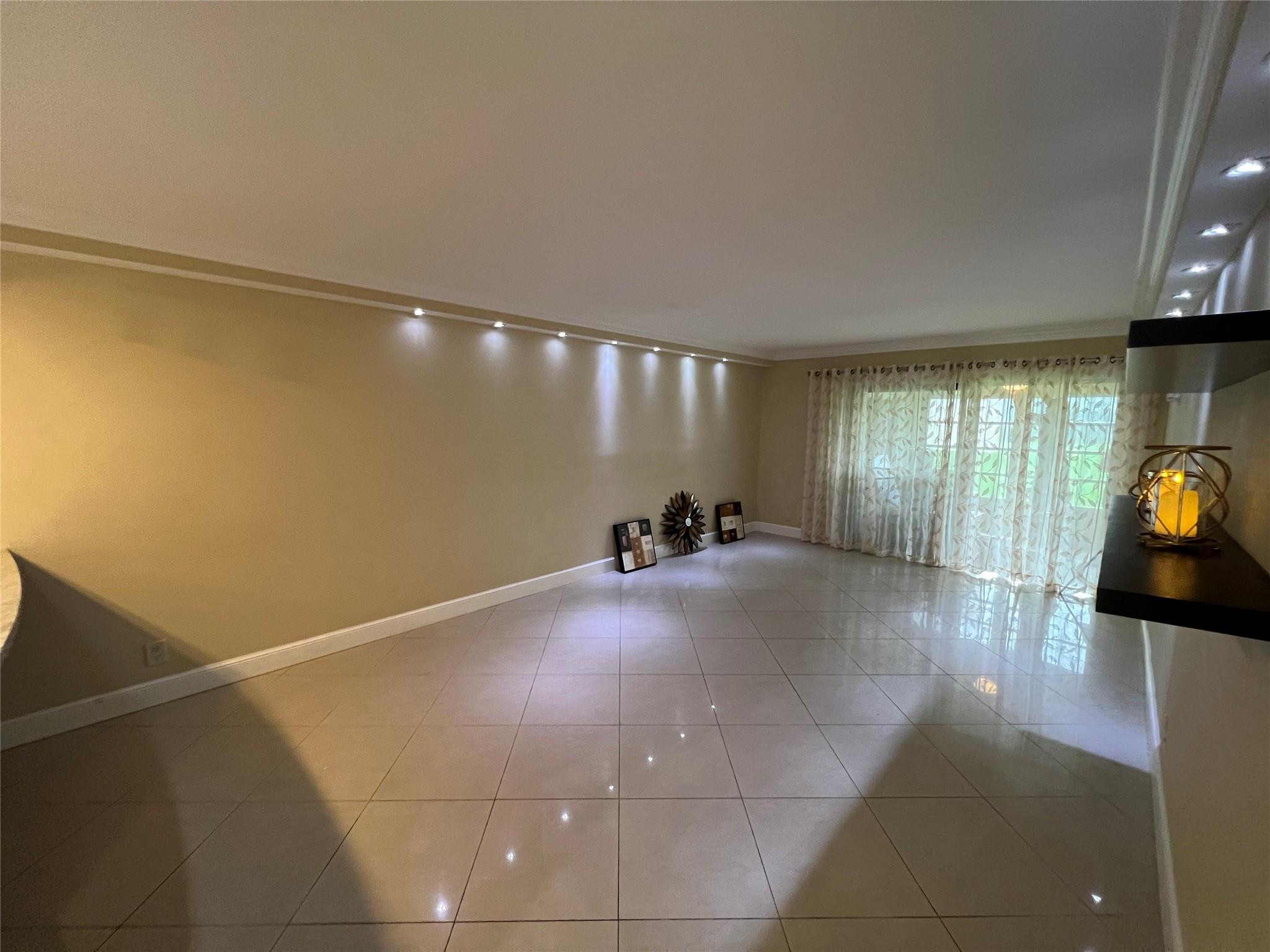 9300 Southwest 8th Street, Unit 108 Boca Raton, FL 33428 - Photo 30 of 40 a view of a livingroom with wooden floor and furniture