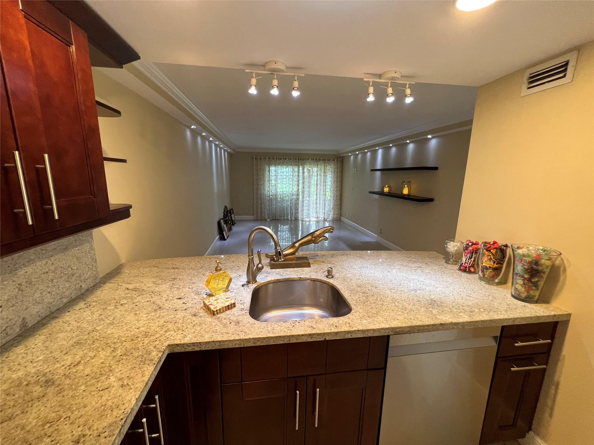 9300 Southwest 8th Street, Unit 108 Boca Raton, FL 33428 - Photo 31 of 40 a kitchen with a sink and a refrigerator