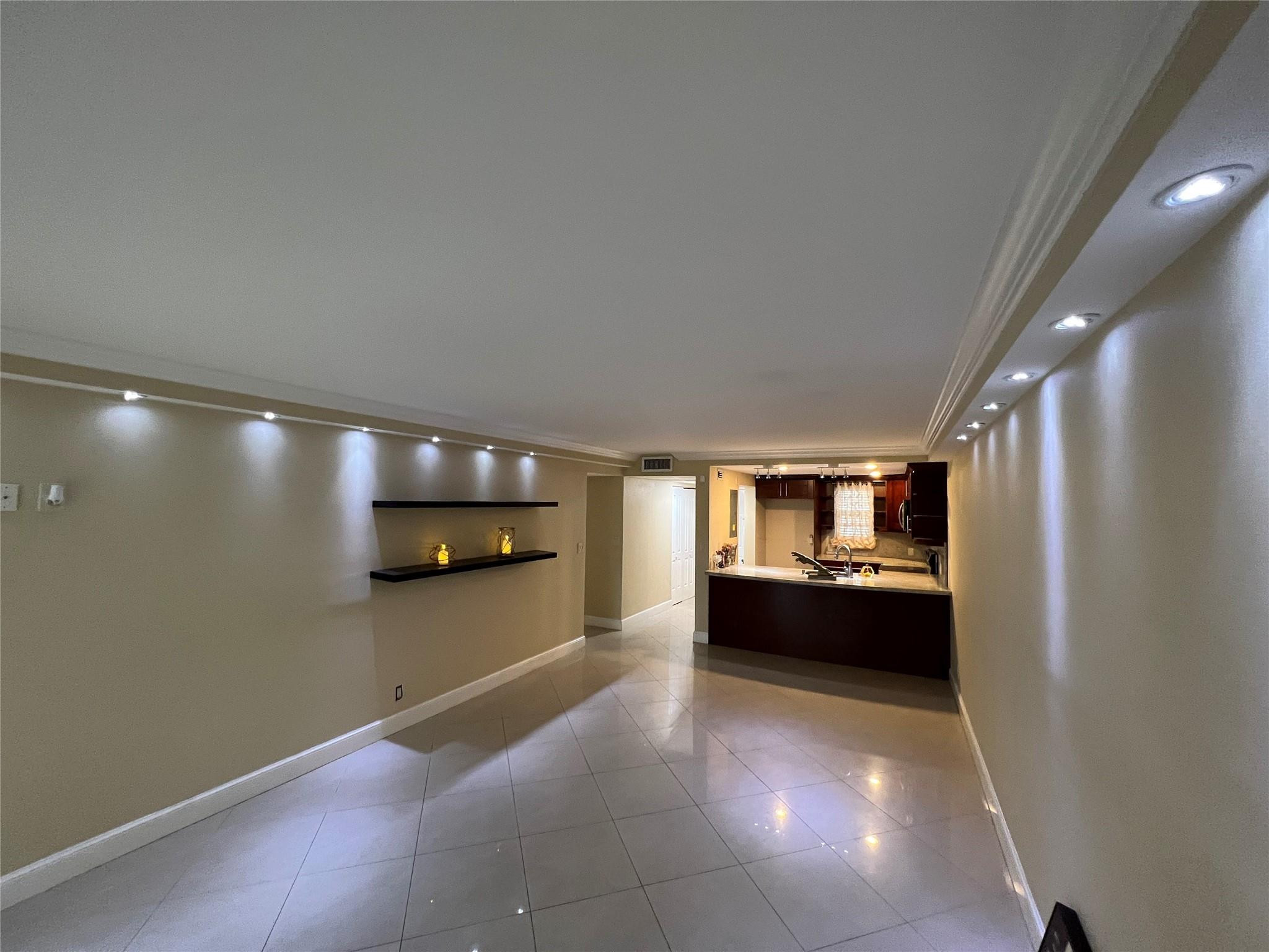9300 Southwest 8th Street, Unit 108 Boca Raton, FL 33428 - Photo 33 of 40 a large empty room with kitchen view