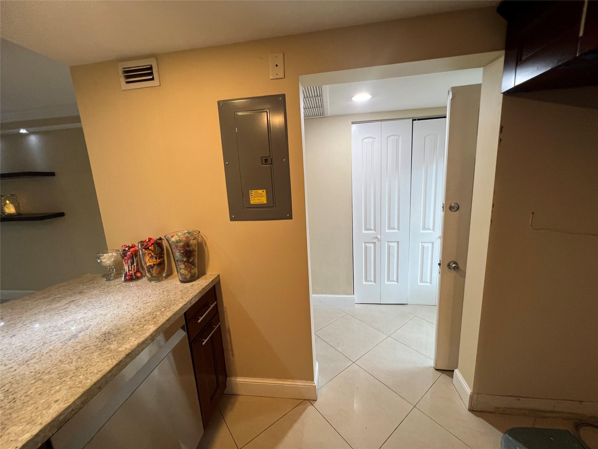 9300 Southwest 8th Street, Unit 108 Boca Raton, FL 33428 - Photo 37 of 40 a kitchen with a sink and a refrigerator