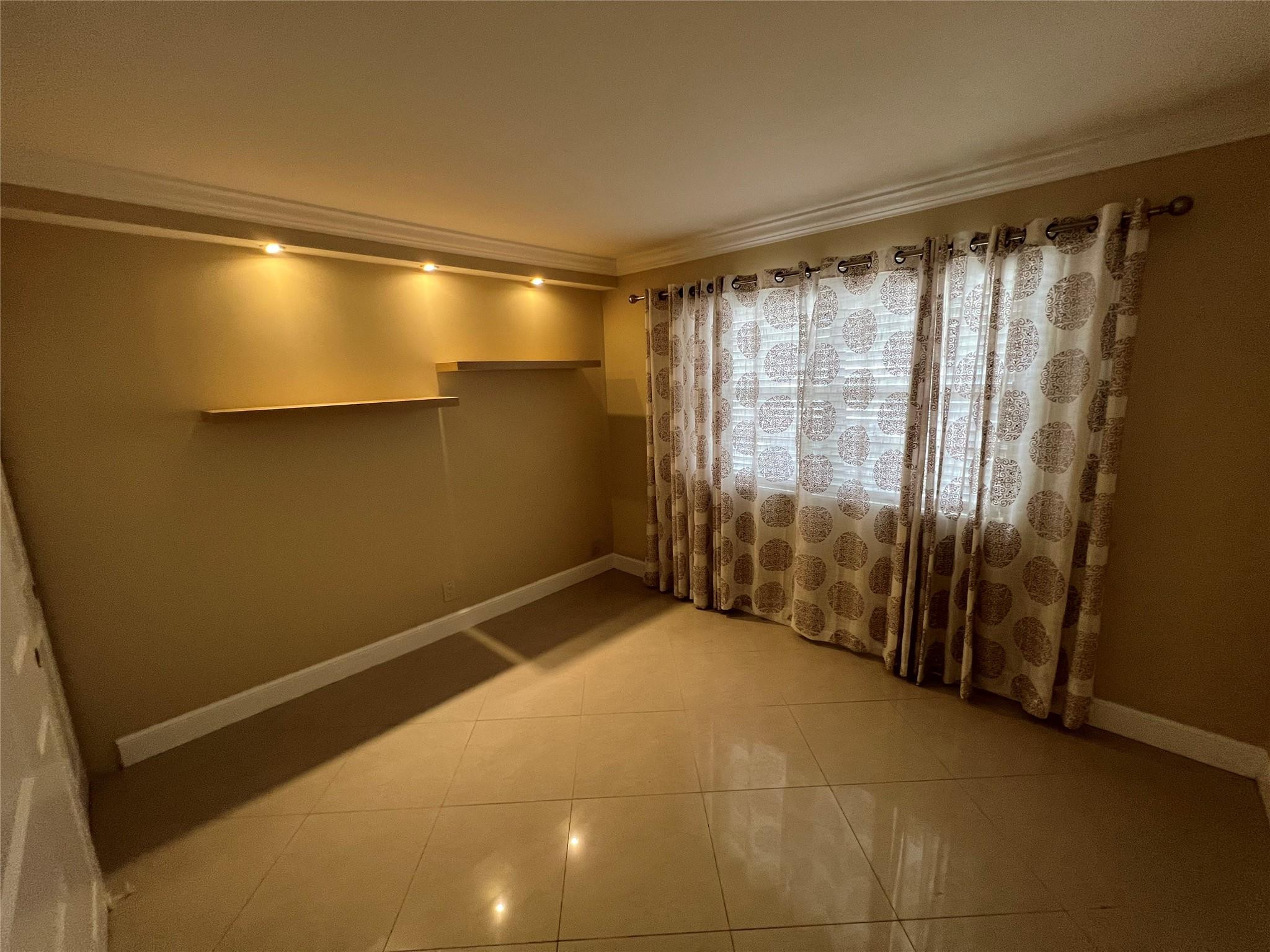 9300 Southwest 8th Street, Unit 108 Boca Raton, FL 33428 - Photo 8 of 40 a view of an empty room with a window