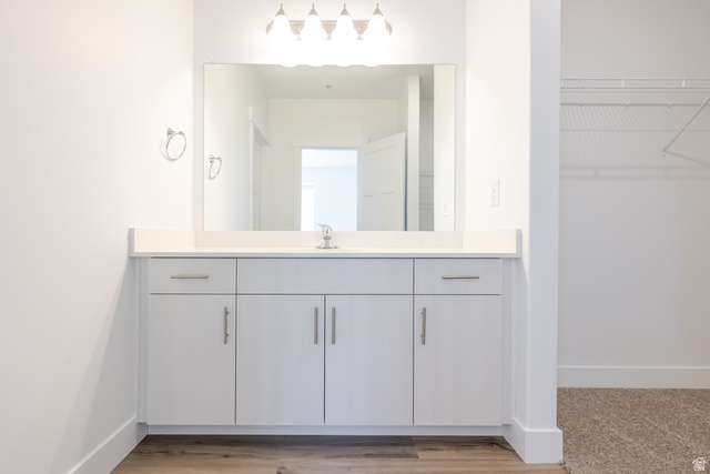 675 West 4500th South, Unit P204 Mapleton, UT 84664 - Photo 9 of 16 Contemporary vanity featuring a rectangular under-mount sink, light-toned countertop, and chrome faucet