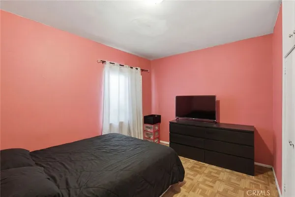 a bedroom with a bed and a flat screen tv