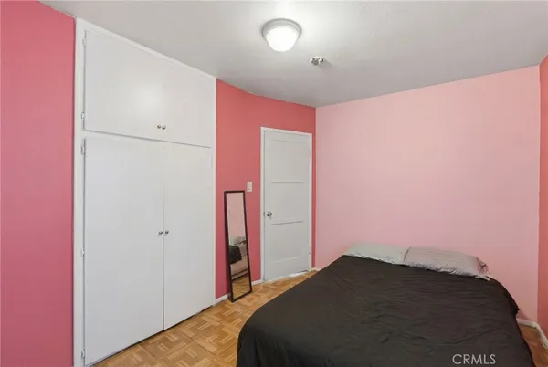 a bedroom with a bed and a mirror