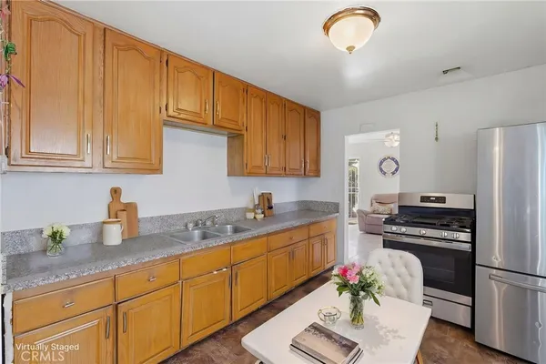 a kitchen with granite countertop a sink stainless steel appliances and cabinets