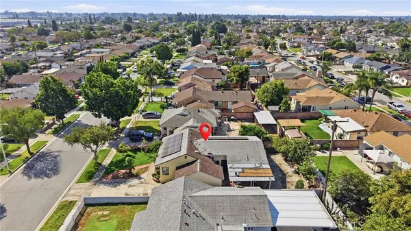 an aerial view of residential houses with outdoor space and street view