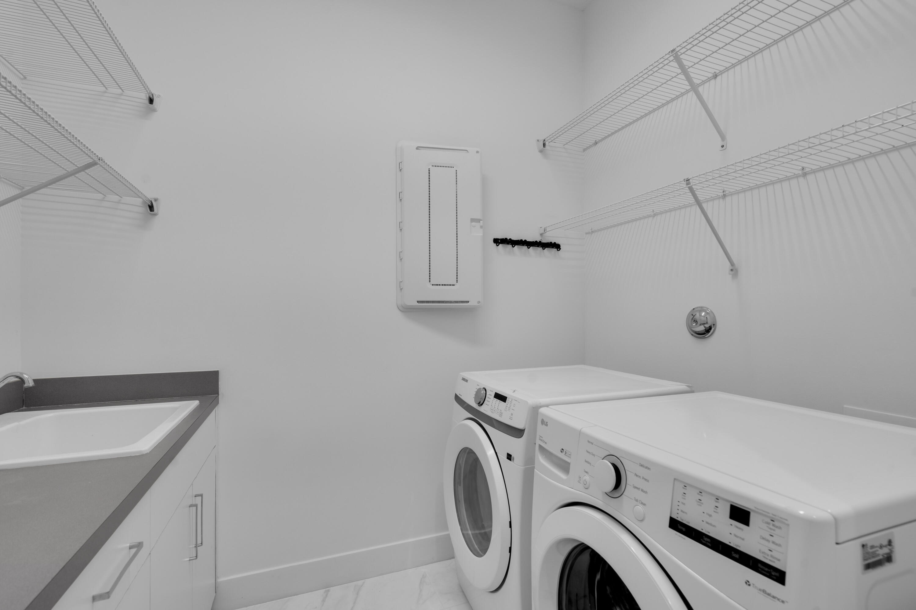 8281 Oceanus Drive Boca Raton, FL 33496 - Photo 25 of 52 a utility room with dryer and washer