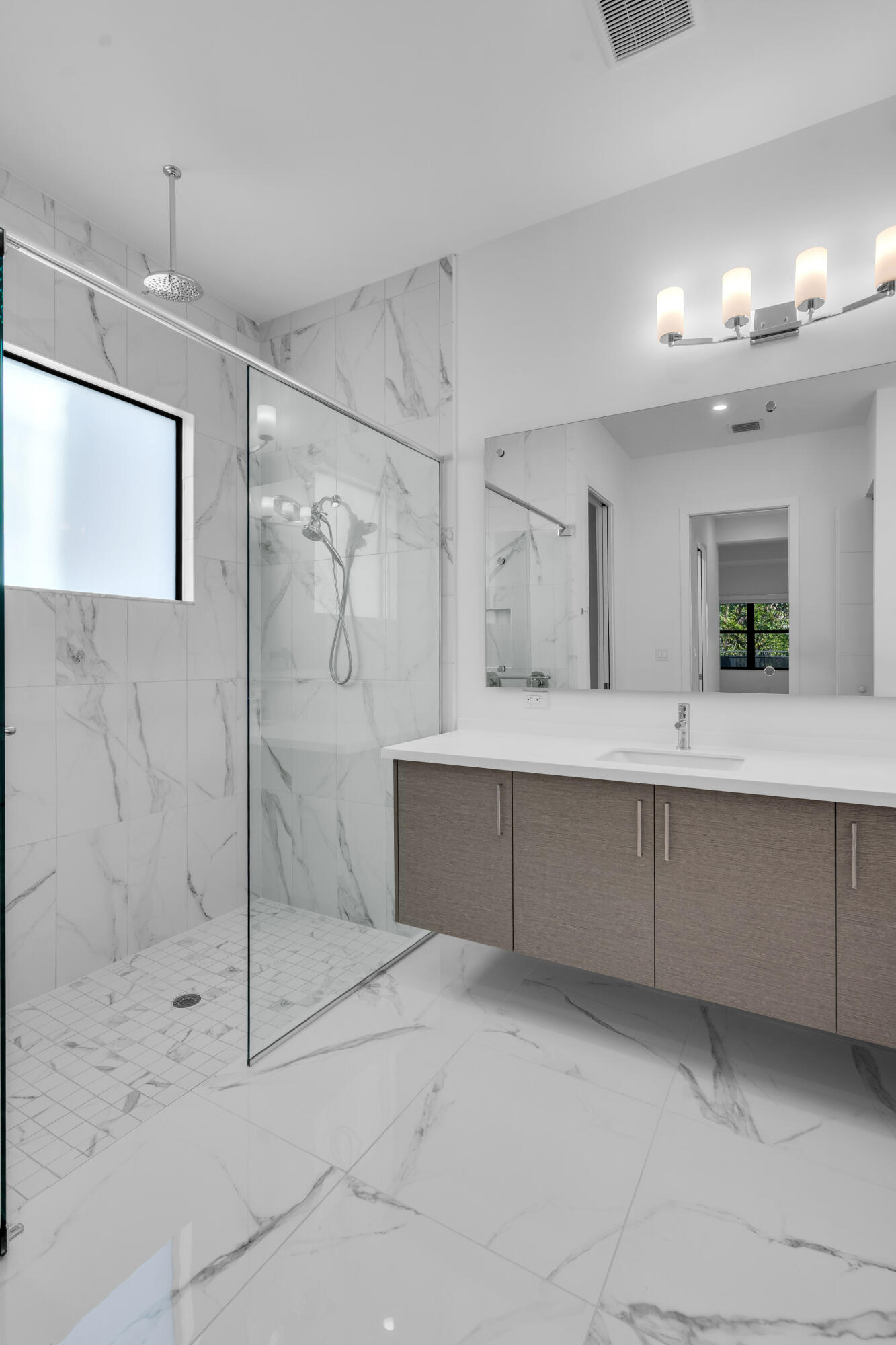 8281 Oceanus Drive Boca Raton, FL 33496 - Photo 30 of 52 a spacious bathroom with a shower a sink and mirror