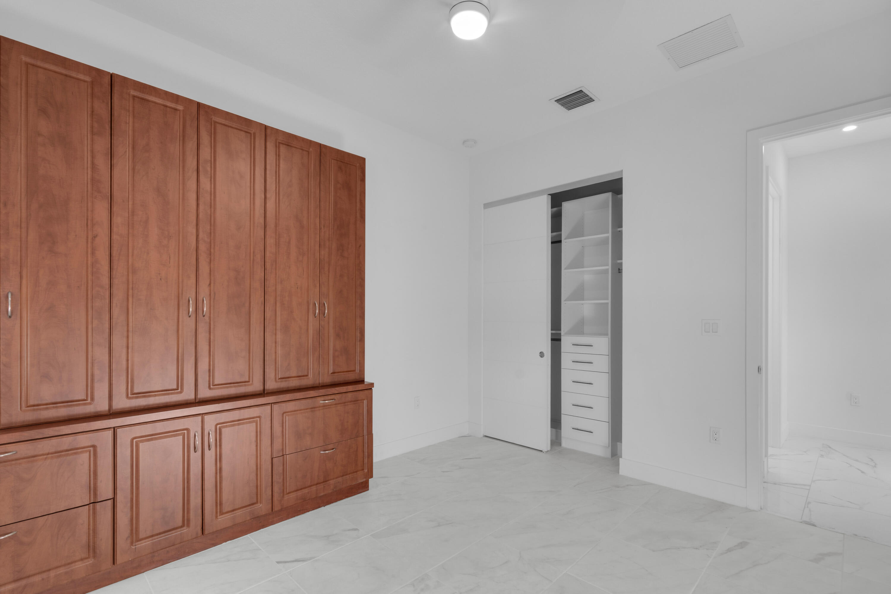 8281 Oceanus Drive Boca Raton, FL 33496 - Photo 37 of 52 an empty room with wooden floor and windows
