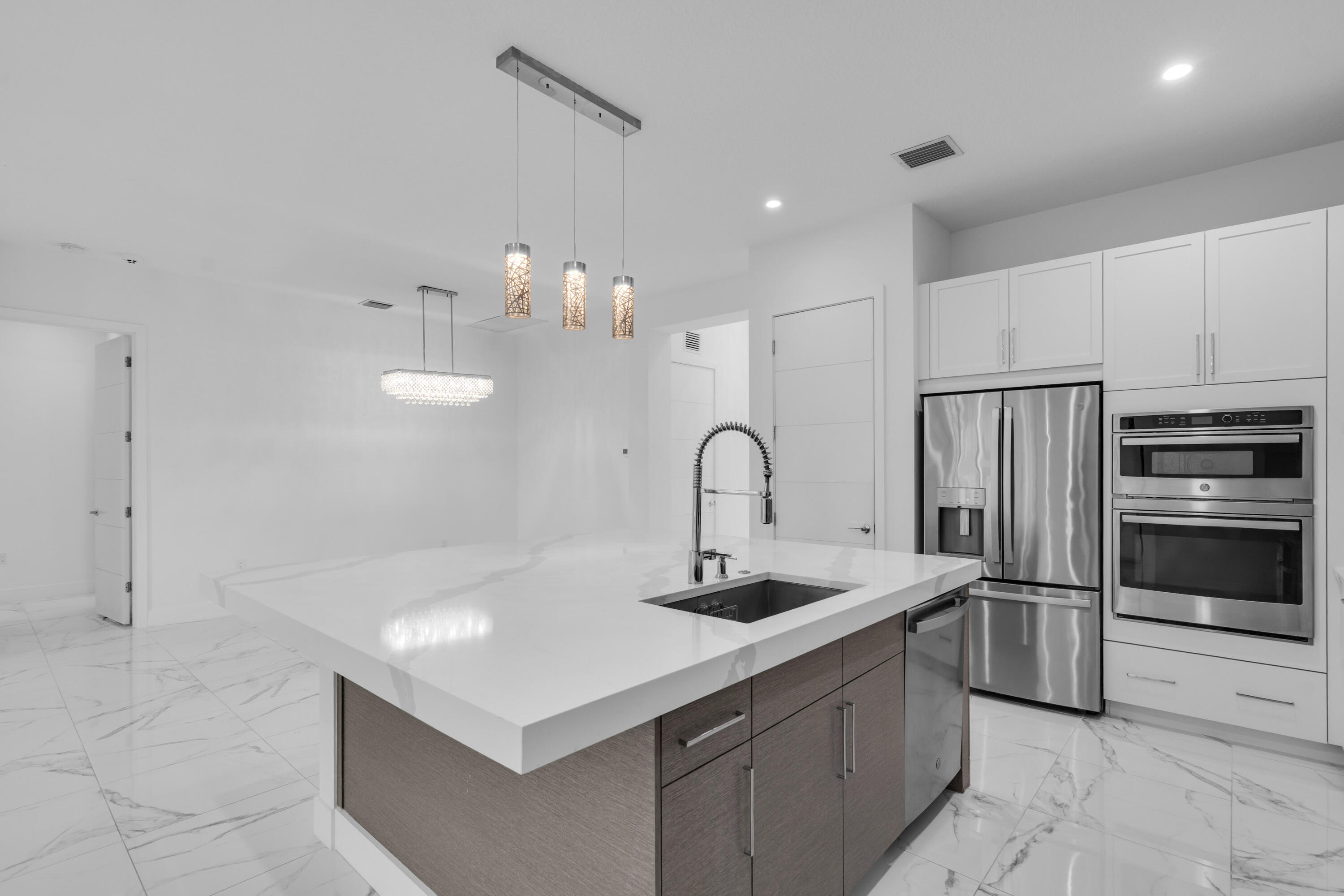 8281 Oceanus Drive Boca Raton, FL 33496 - Photo 42 of 52 a kitchen that has a lot of cabinets and stainless steel appliances