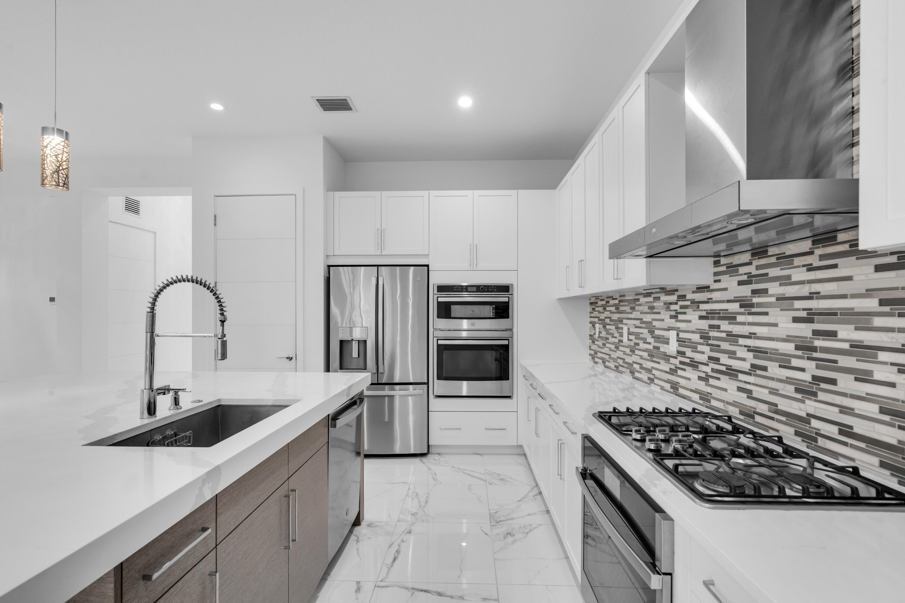 8281 Oceanus Drive Boca Raton, FL 33496 - Photo 43 of 52 a kitchen with stainless steel appliances granite countertop a sink stove and refrigerator