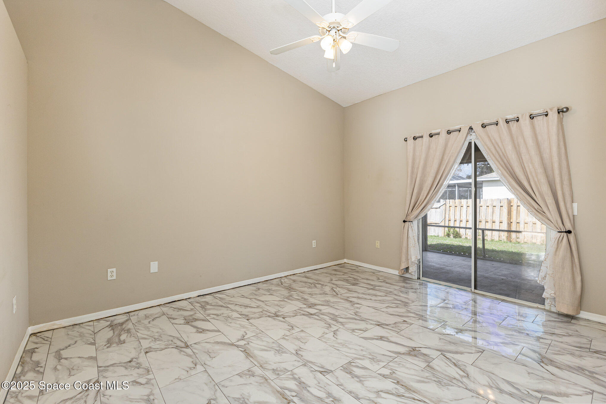 6480 Annapolis Street Cocoa, FL 32927 - Photo 13 of 30 an empty room with windows and fan