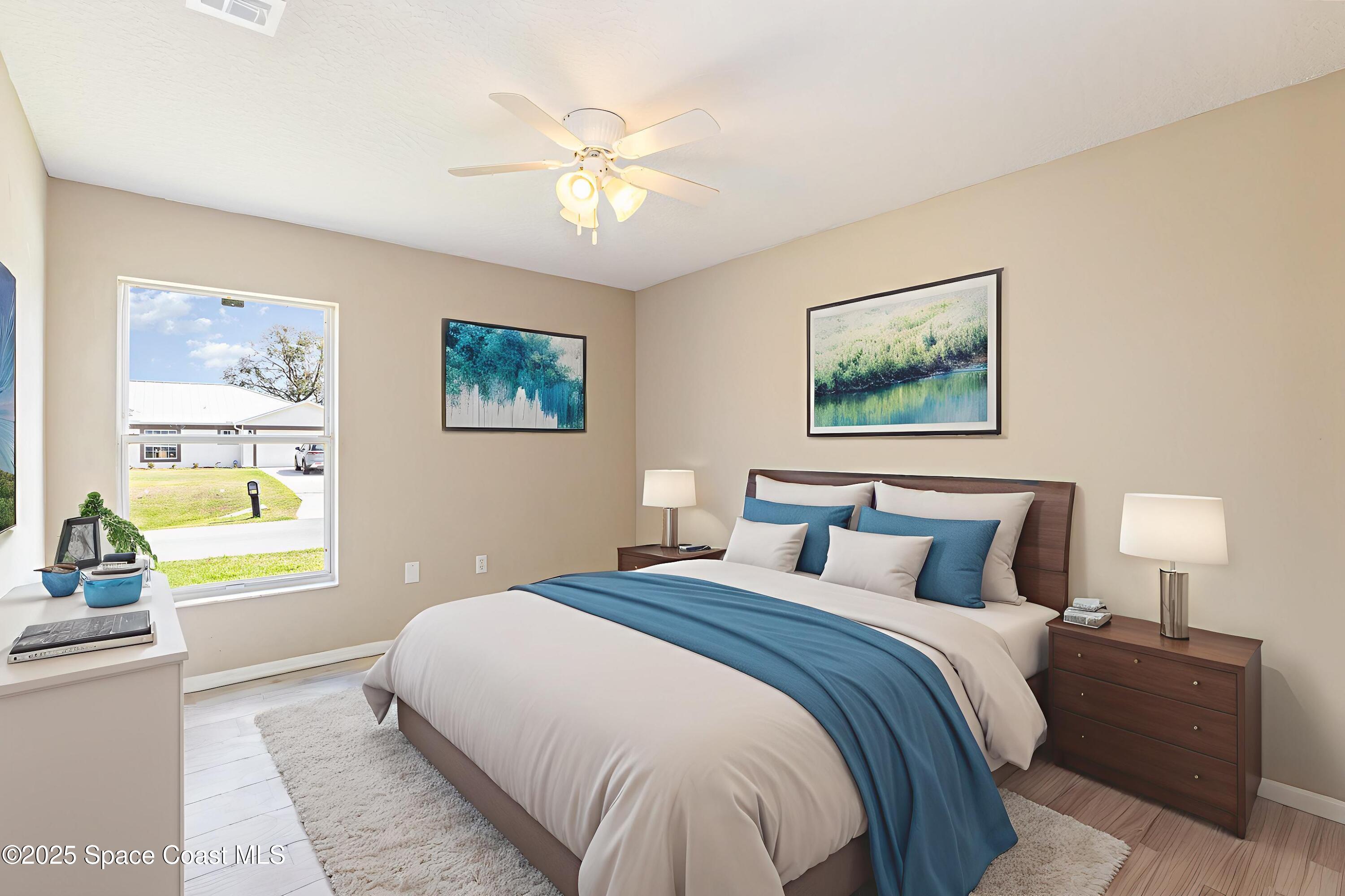 6480 Annapolis Street Cocoa, FL 32927 - Photo 19 of 30 a bedroom with bed and paintings on the wall