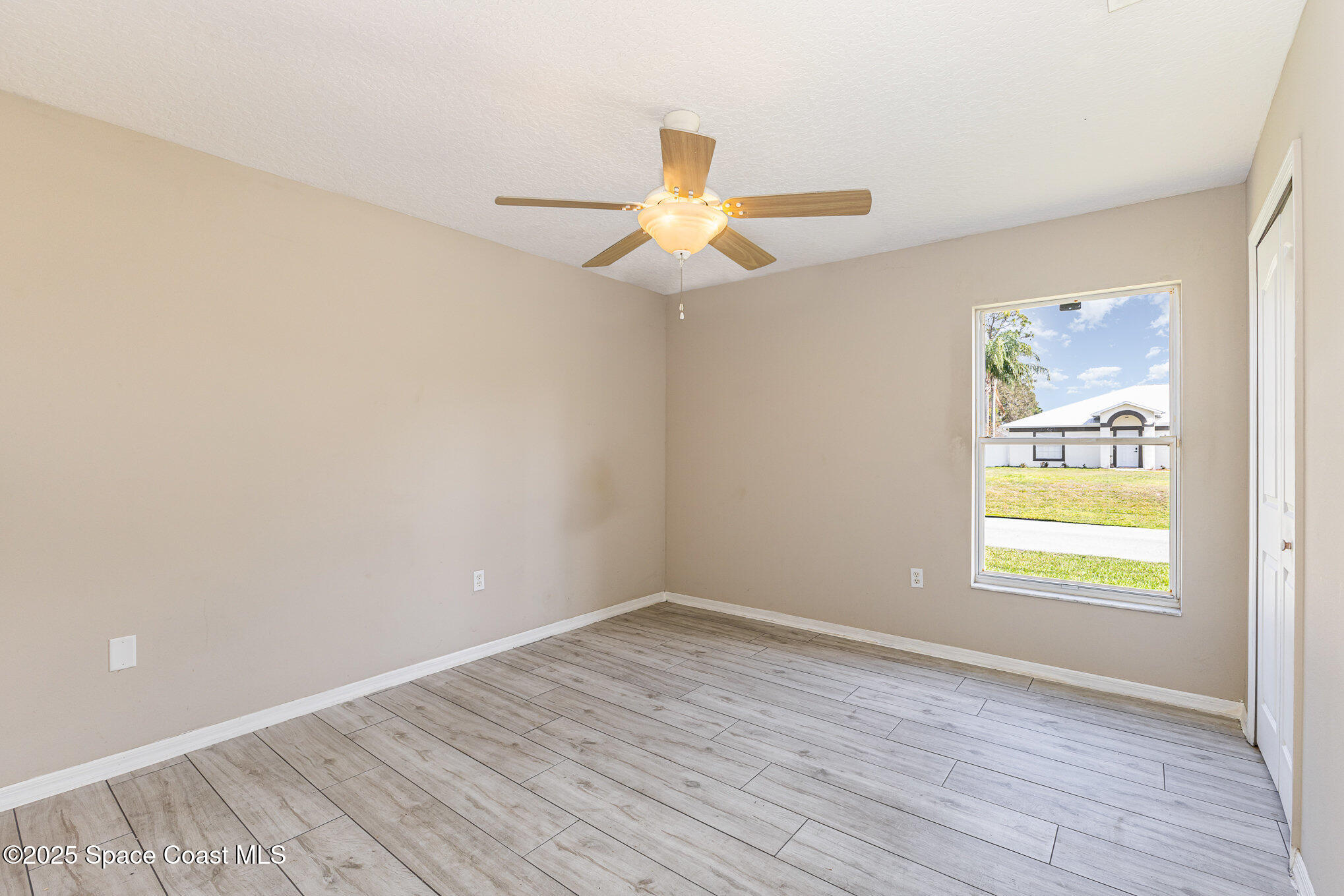 6480 Annapolis Street Cocoa, FL 32927 - Photo 21 of 30 wooden floor in an empty room with a window