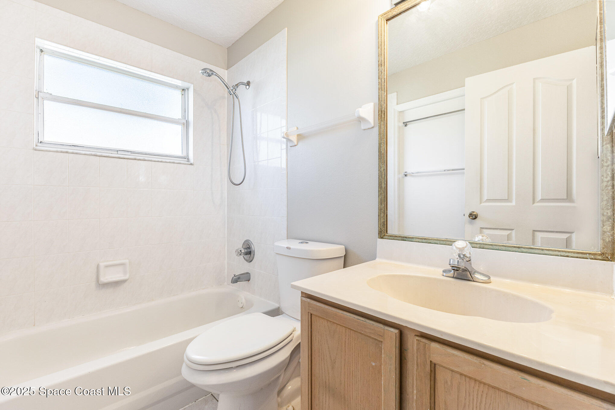 6480 Annapolis Street Cocoa, FL 32927 - Photo 22 of 30 a bathroom with a sink toilet and shower