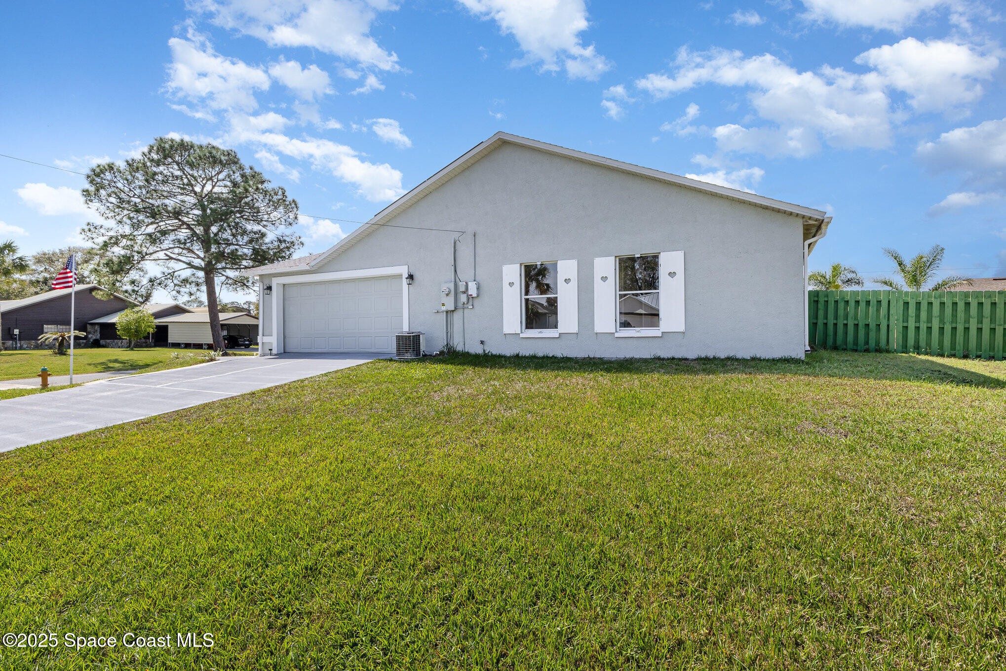 6480 Annapolis Street Cocoa, FL 32927 - Photo 30 of 30 a front view of house with yard and green space