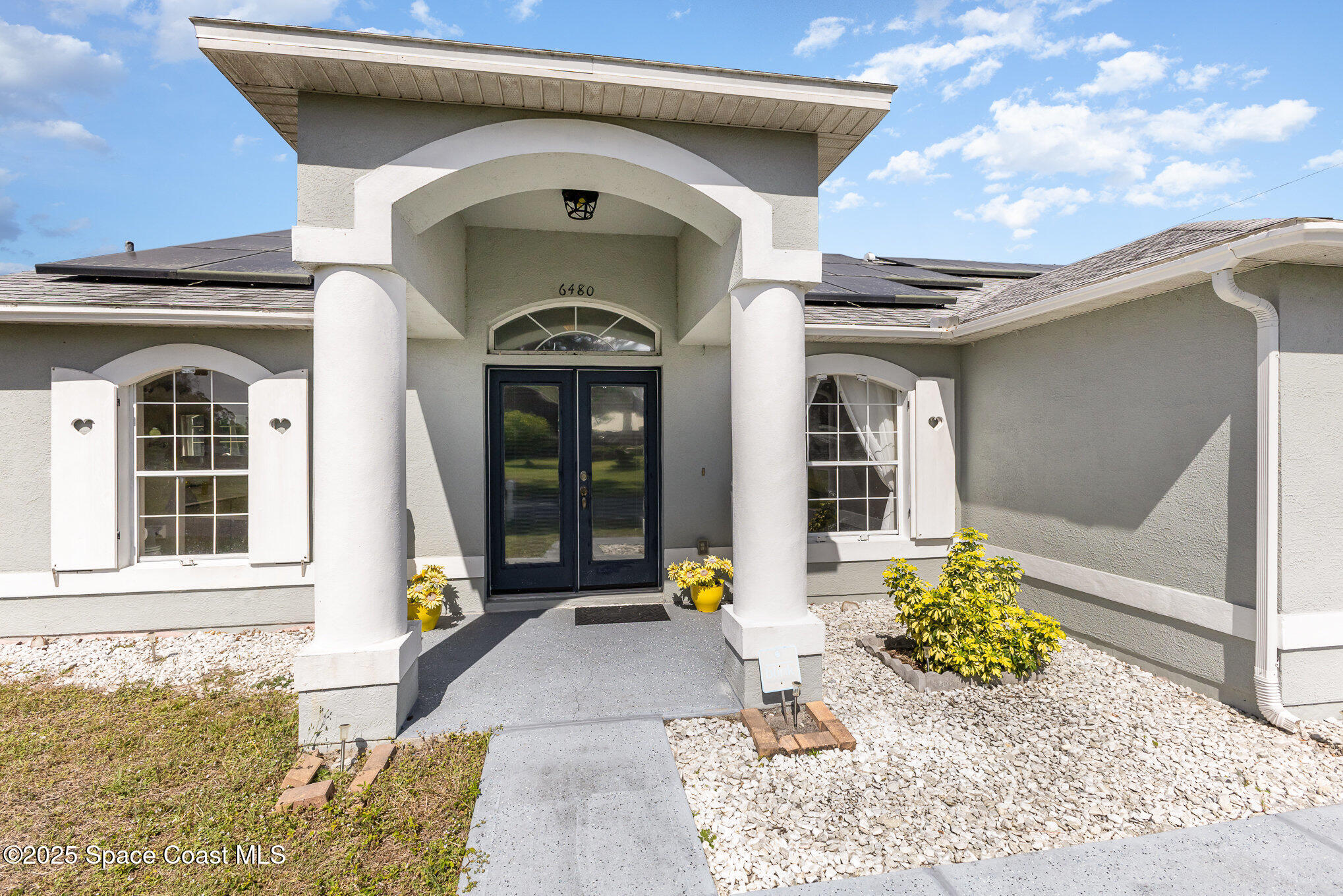 6480 Annapolis Street Cocoa, FL 32927 - Photo 3 of 30 a front view of a house with garden