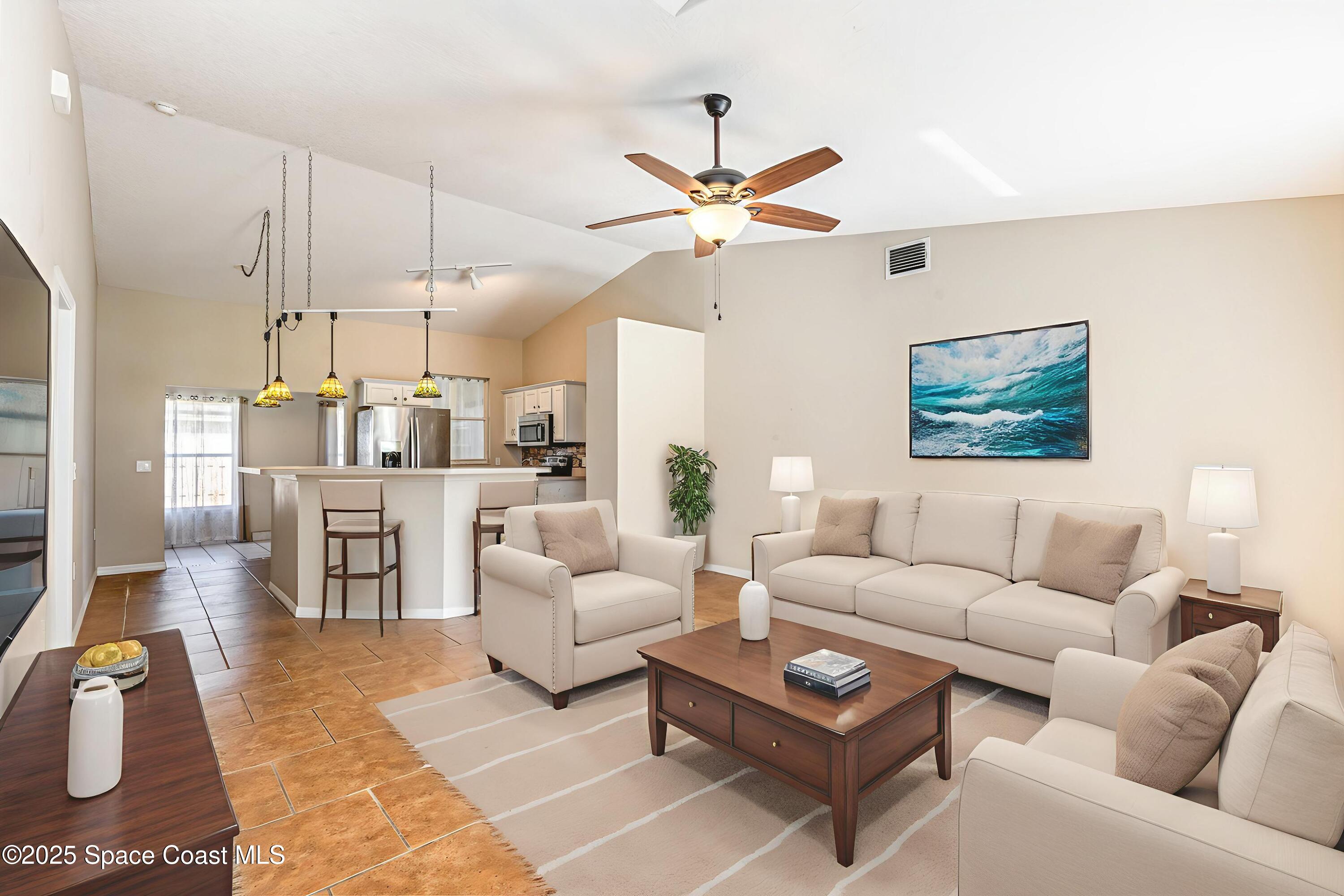 6480 Annapolis Street Cocoa, FL 32927 - Photo 6 of 30 a living room with furniture a ceiling fan and a rug