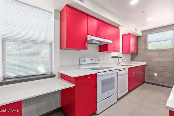 a kitchen with a sink stove and cabinets