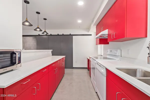a kitchen with stainless steel appliances a sink and a refrigerator