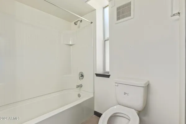 a bathroom with a bathtub toilet and shower