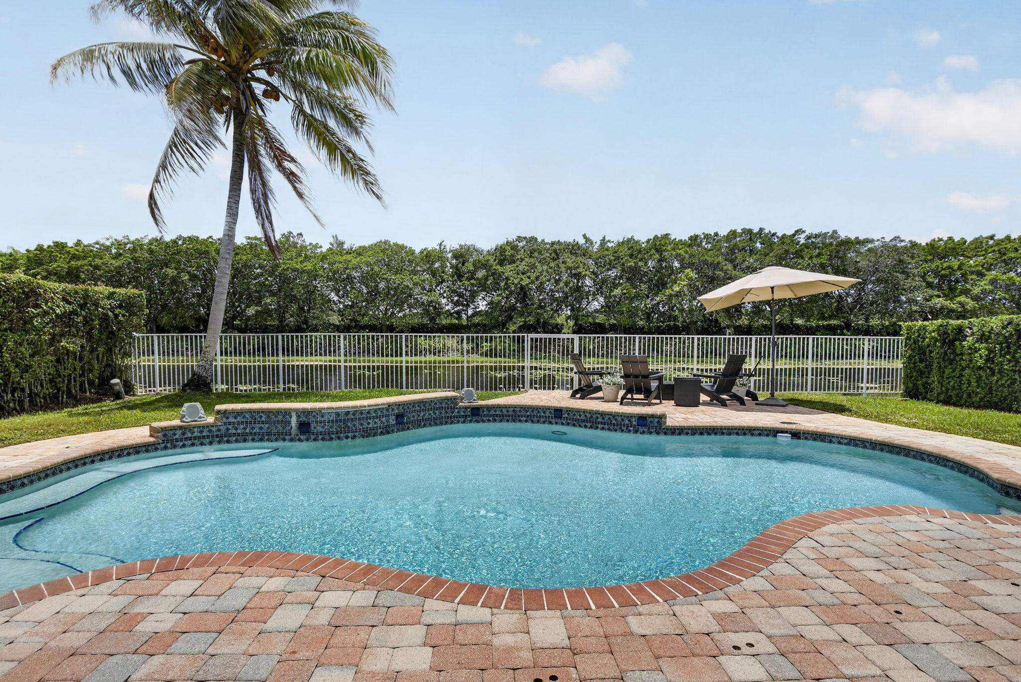 4299 Laurel Ridge Circle Weston, FL 33331 - Photo 42 of 103 a view of a swimming pool with a lounge chair