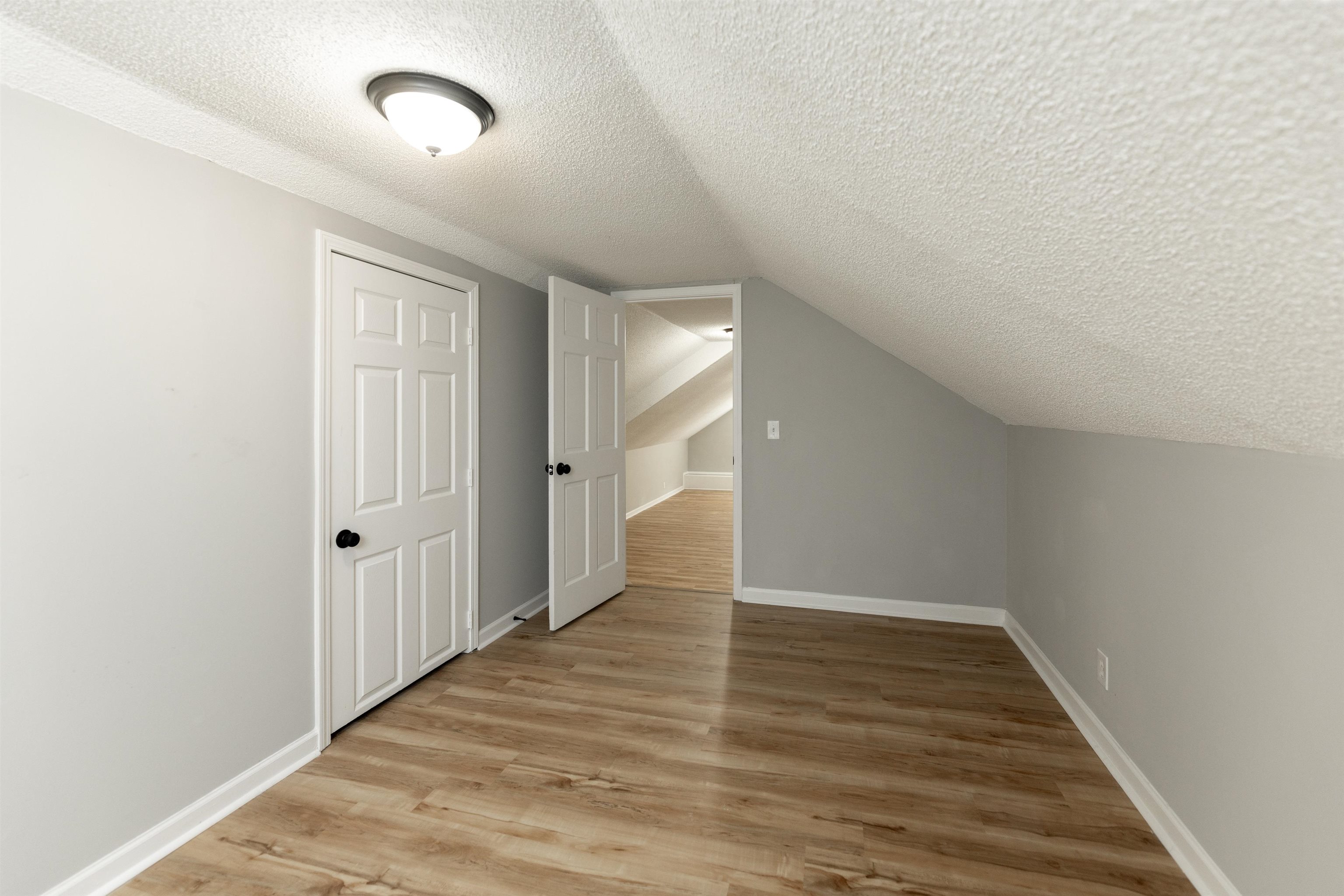 7421 Richmond Road Memphis, TN 38125 - Photo 34 of 39 Room featuring wood-finish flooring, light gray walls, white baseboards, and a semi-flush mount ceiling light