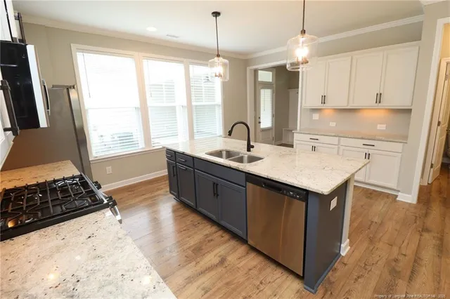 a kitchen with a sink stove and refrigerator