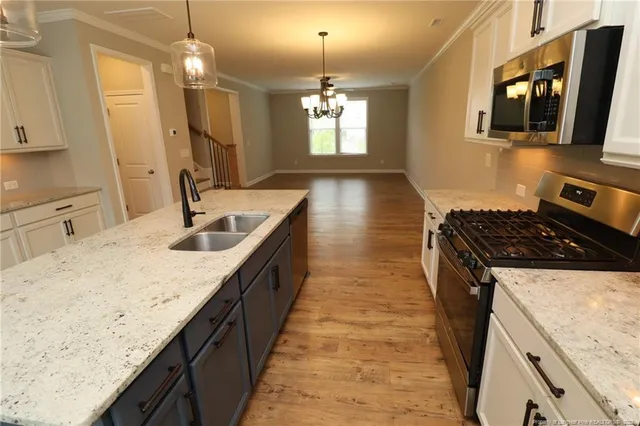 a kitchen with sink stove and microwave