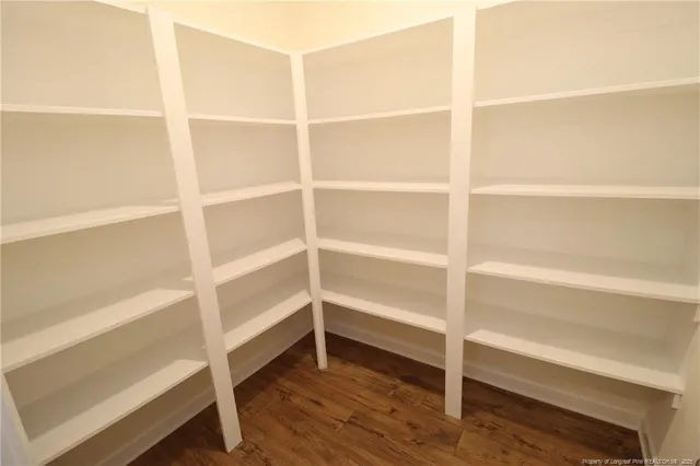 a view of walk in closet with empty racks