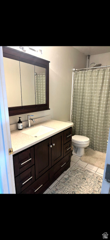 1324 West Raintree Drive, Unit 44 Price, UT 84501 - Photo 15 of 25 Bathroom featuring a dark wood-finish vanity with a light-toned countertop and an undermount sink