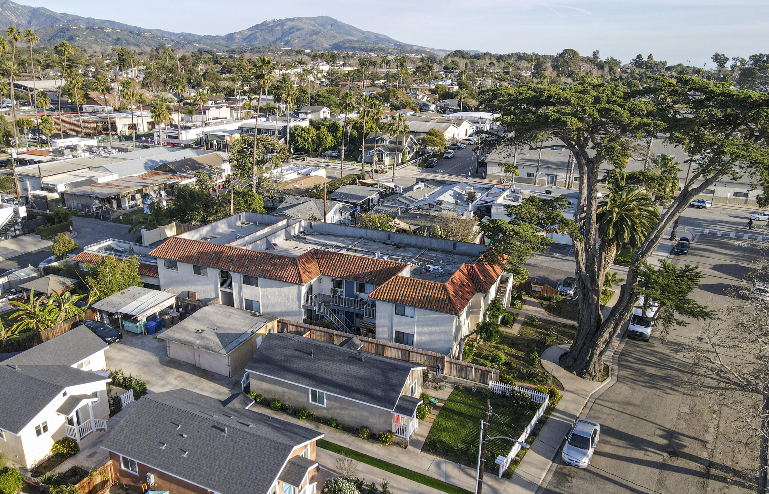 an aerial view of multiple houses with yard