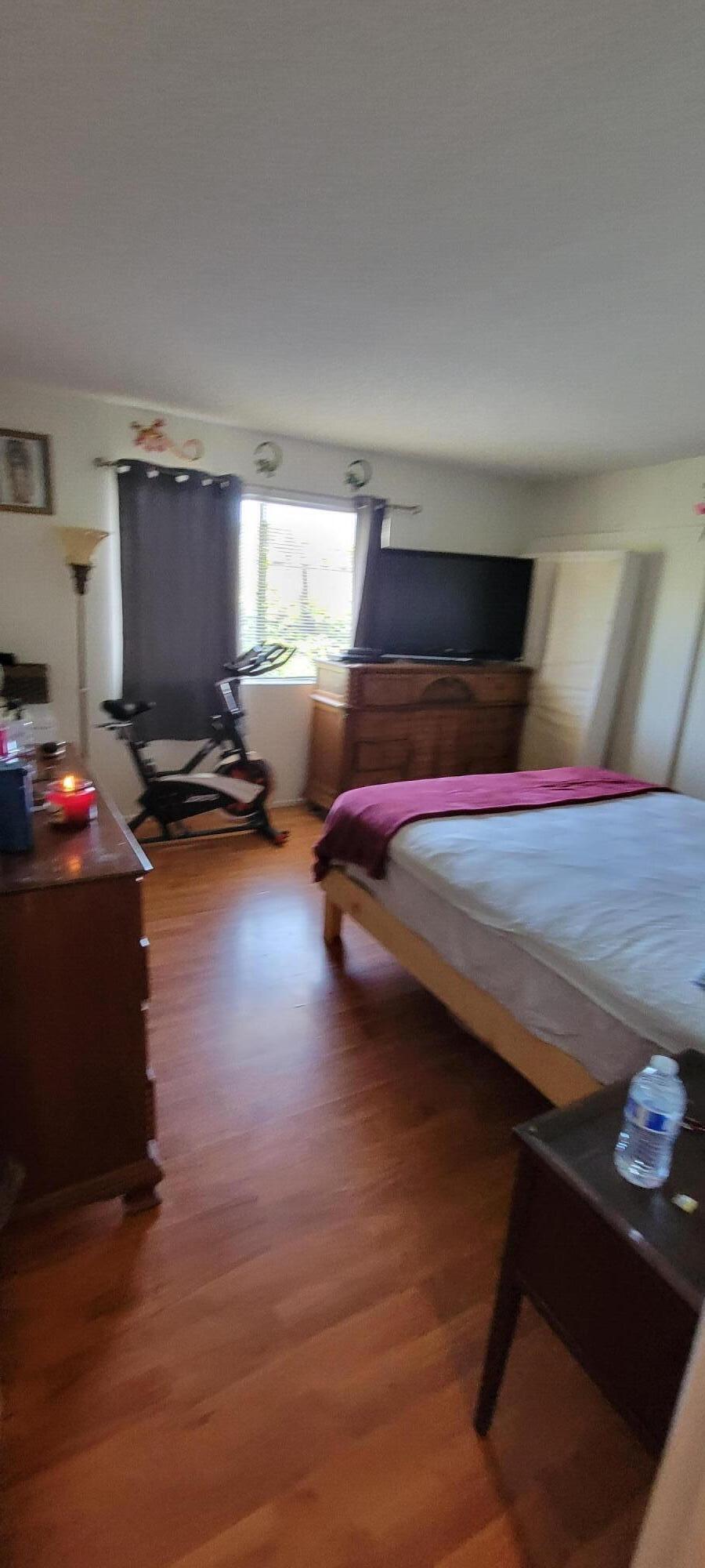 4956 5th Street Carpinteria, CA 93013 - Photo 15 of 16 a bedroom with a bed gym equipment and view of living room