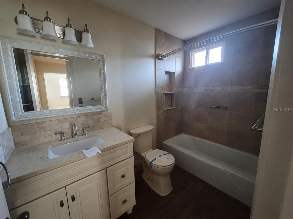 1702 Ketch Place Brandon, FL 33511 - Photo 7 of 14 a bathroom with a bathtub shower sink vanity and toilet