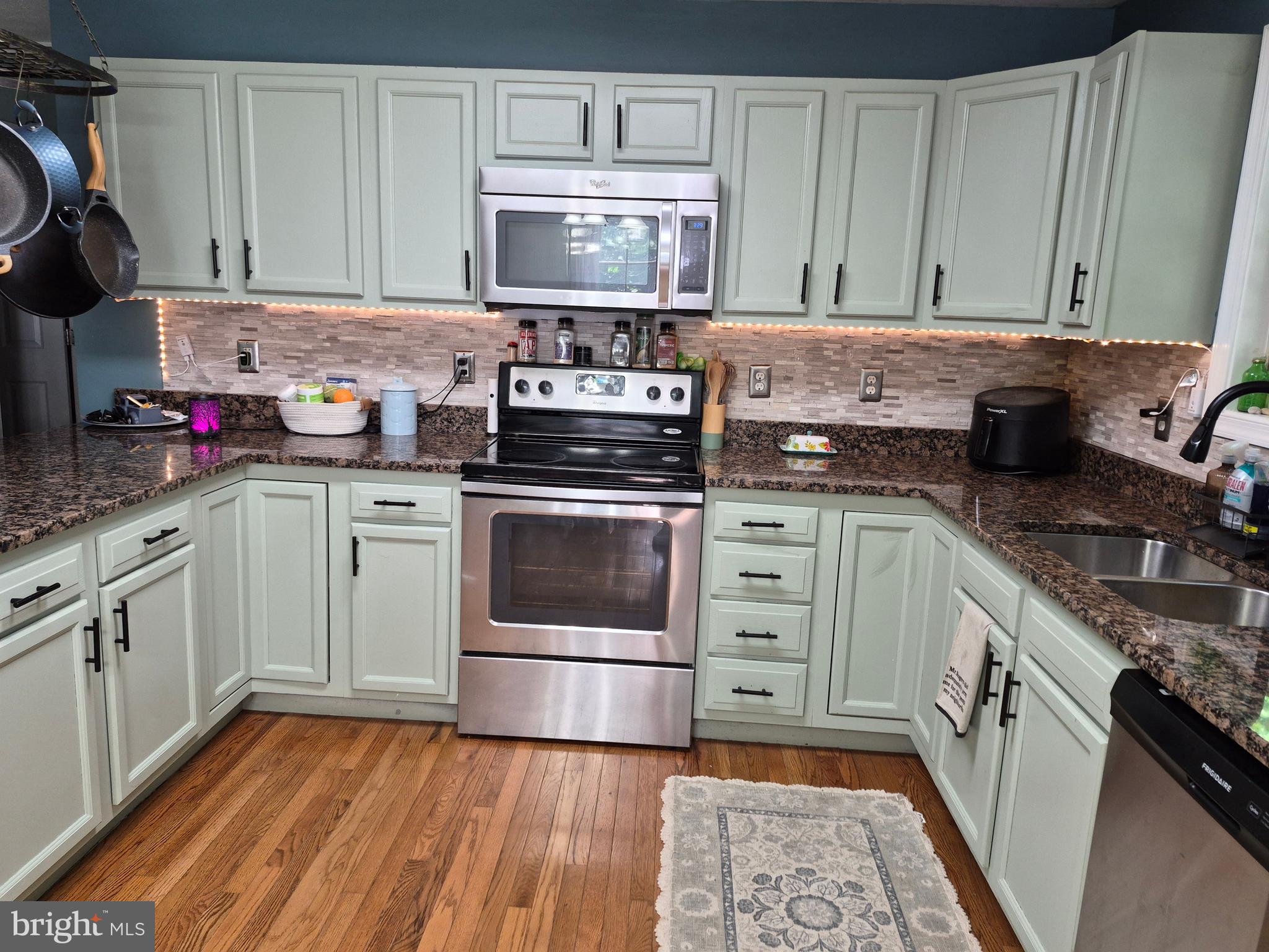 1440 Drummer Hill Road Front Royal, VA 22630 - Photo 23 of 42 a kitchen with stainless steel appliances granite countertop a stove a sink dishwasher and cabinets with wooden floor