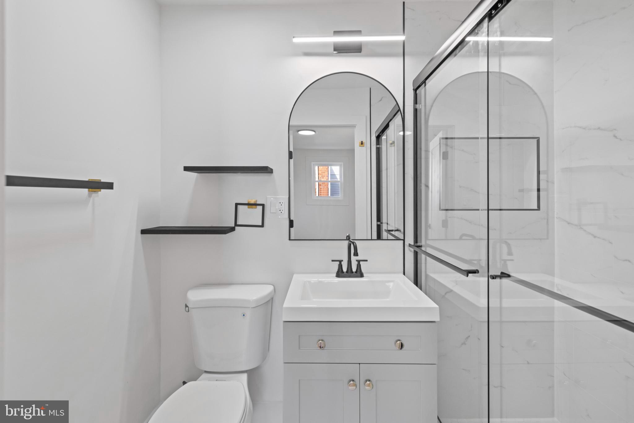 4821 Topping Road Rockville, MD 20852 - Photo 18 of 45 a bathroom with a toilet sink and mirror