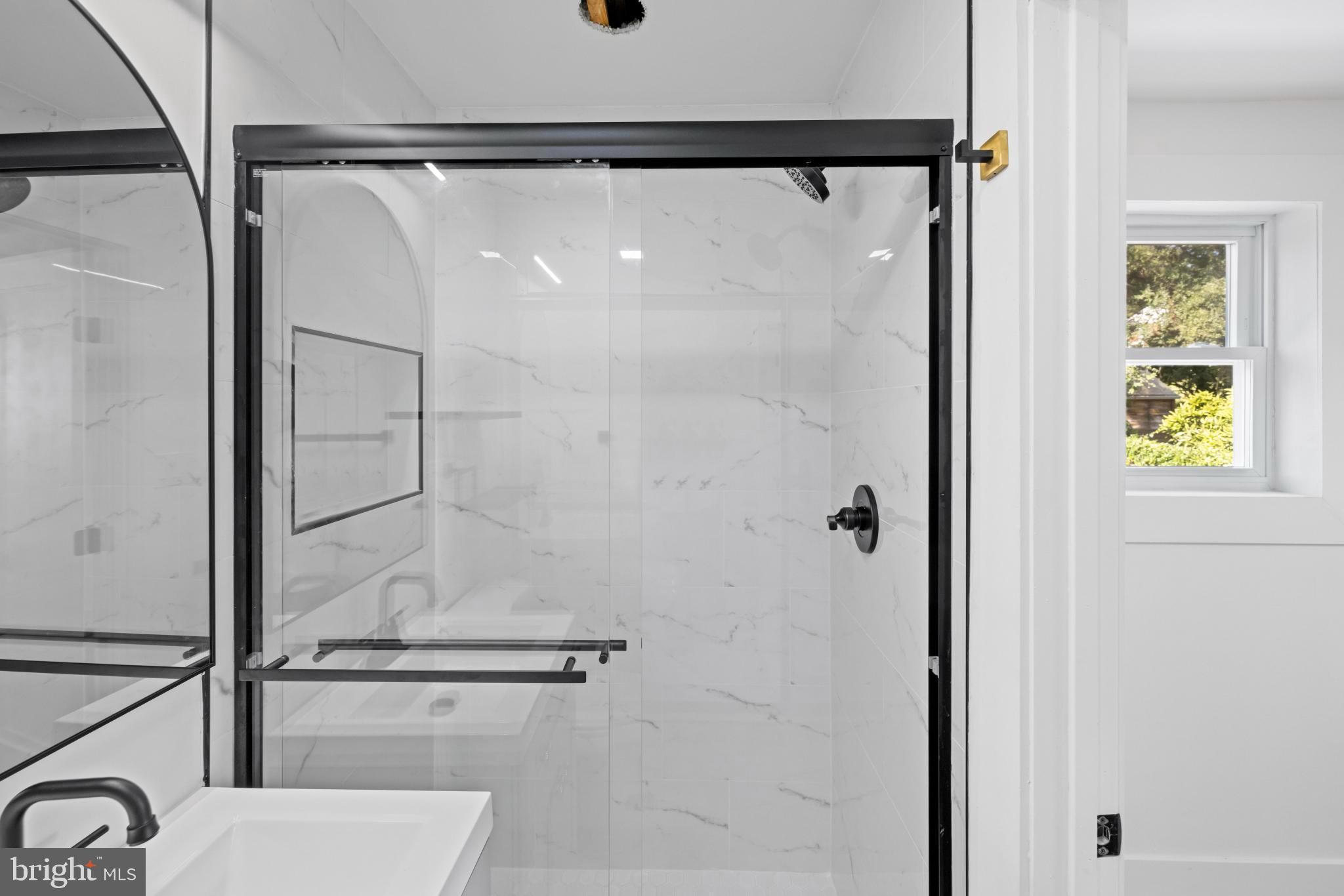 4821 Topping Road Rockville, MD 20852 - Photo 19 of 45 a bathroom with a shower and a glass door