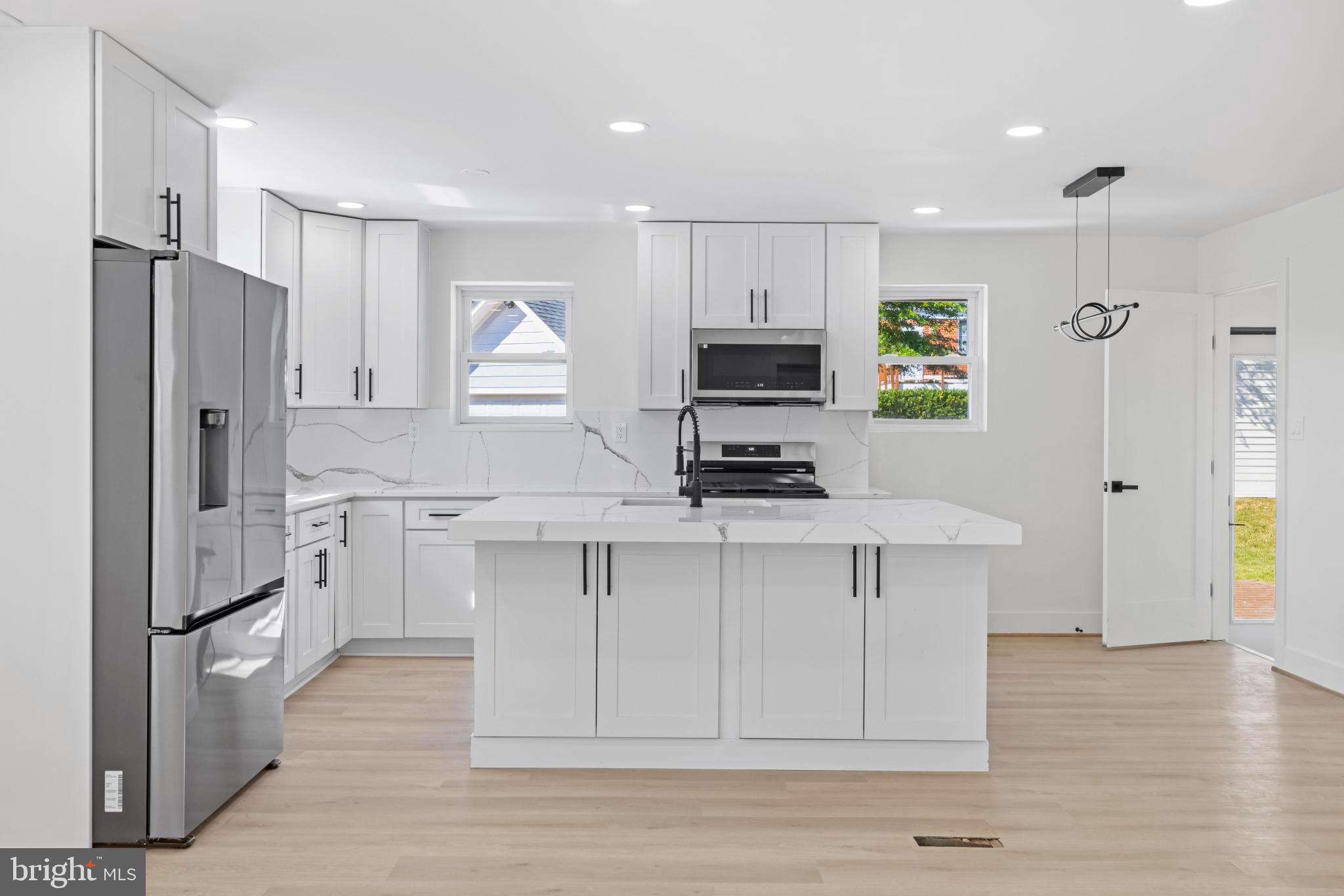 4821 Topping Road Rockville, MD 20852 - Photo 7 of 45 a kitchen with white cabinets and stainless steel appliances
