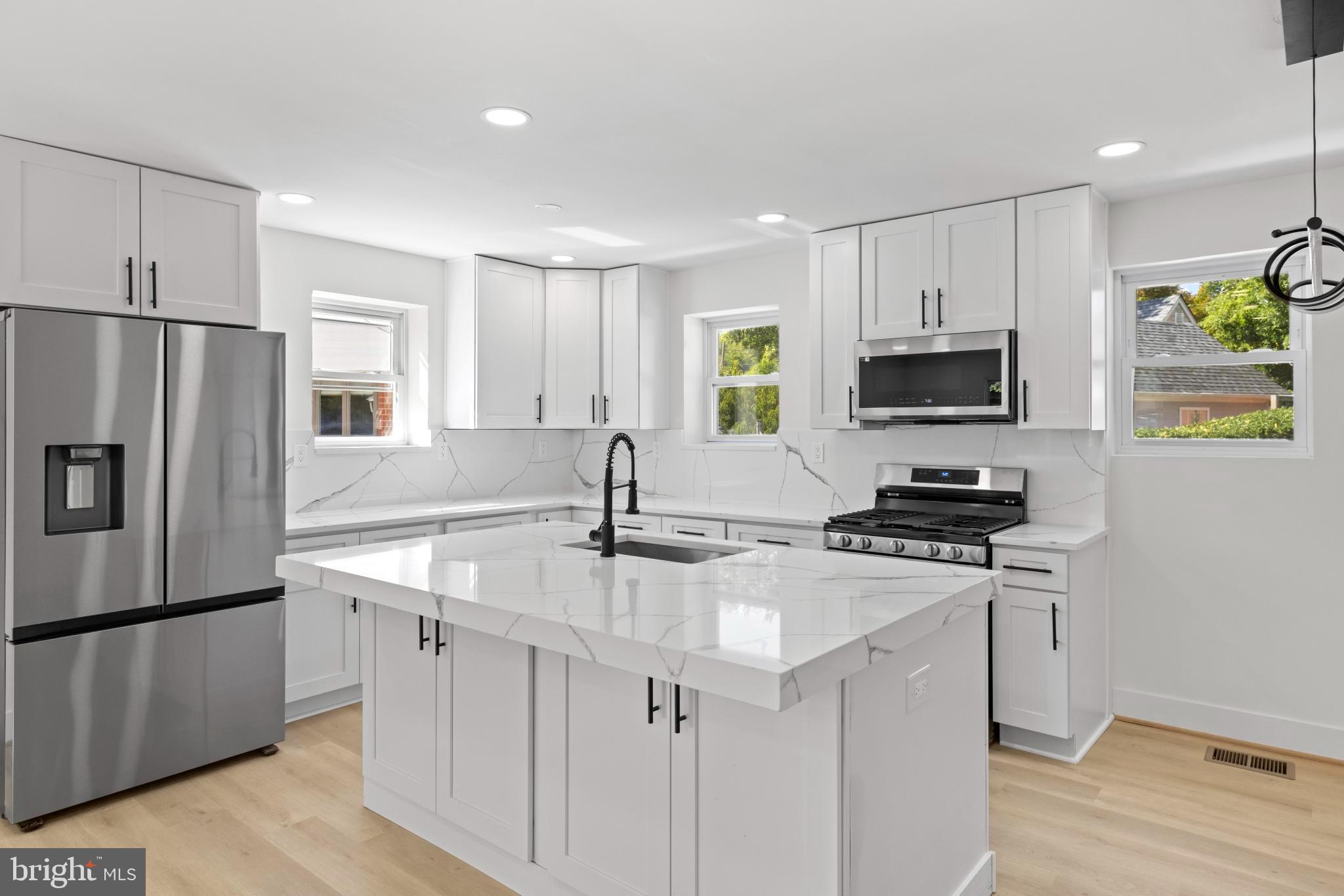 4821 Topping Road Rockville, MD 20852 - Photo 9 of 45 a kitchen with stainless steel appliances a sink a stove a refrigerator cabinets and a window