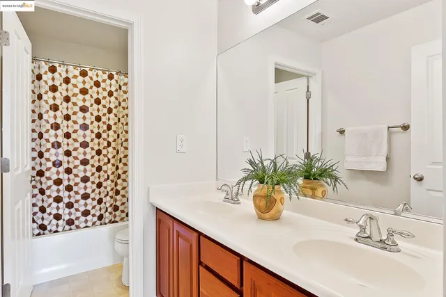 a bathroom with a sink double vanity and a shower
