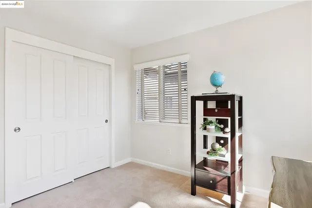 a spacious bedroom with a bed and a window