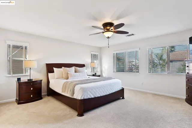 a bedroom with bed and a chandelier