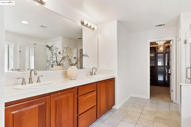 a bathroom with a tub sink and mirror