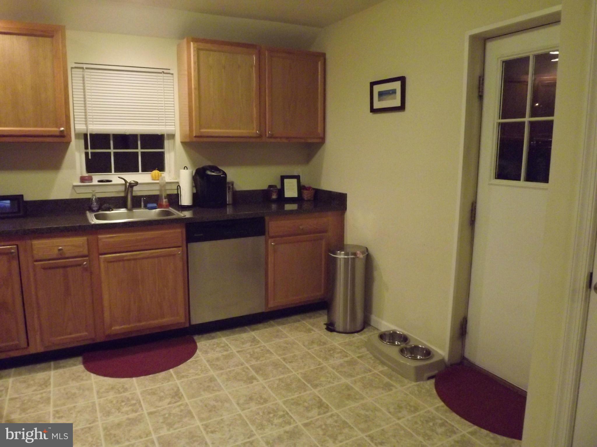3167 Baybriar Road Baltimore, MD 21222 - Photo 18 of 30 a kitchen with stainless steel appliances granite countertop a sink a stove a refrigerator a window