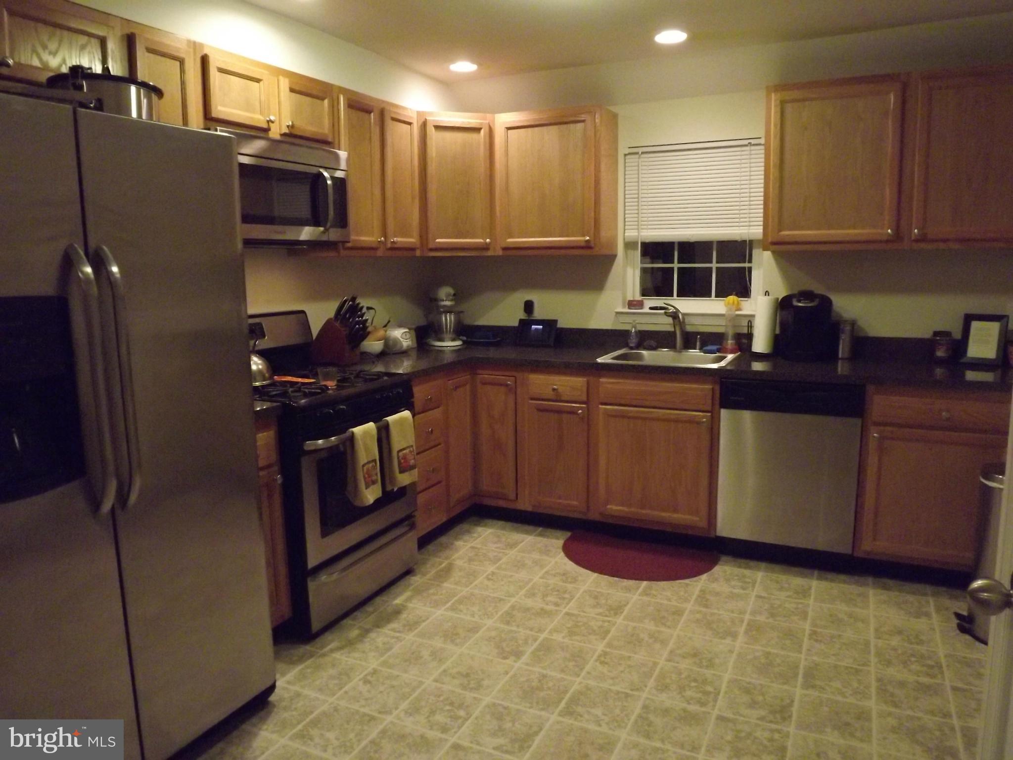 3167 Baybriar Road Baltimore, MD 21222 - Photo 19 of 30 a kitchen with stainless steel appliances granite countertop a stove a sink dishwasher a refrigerator and a microwave