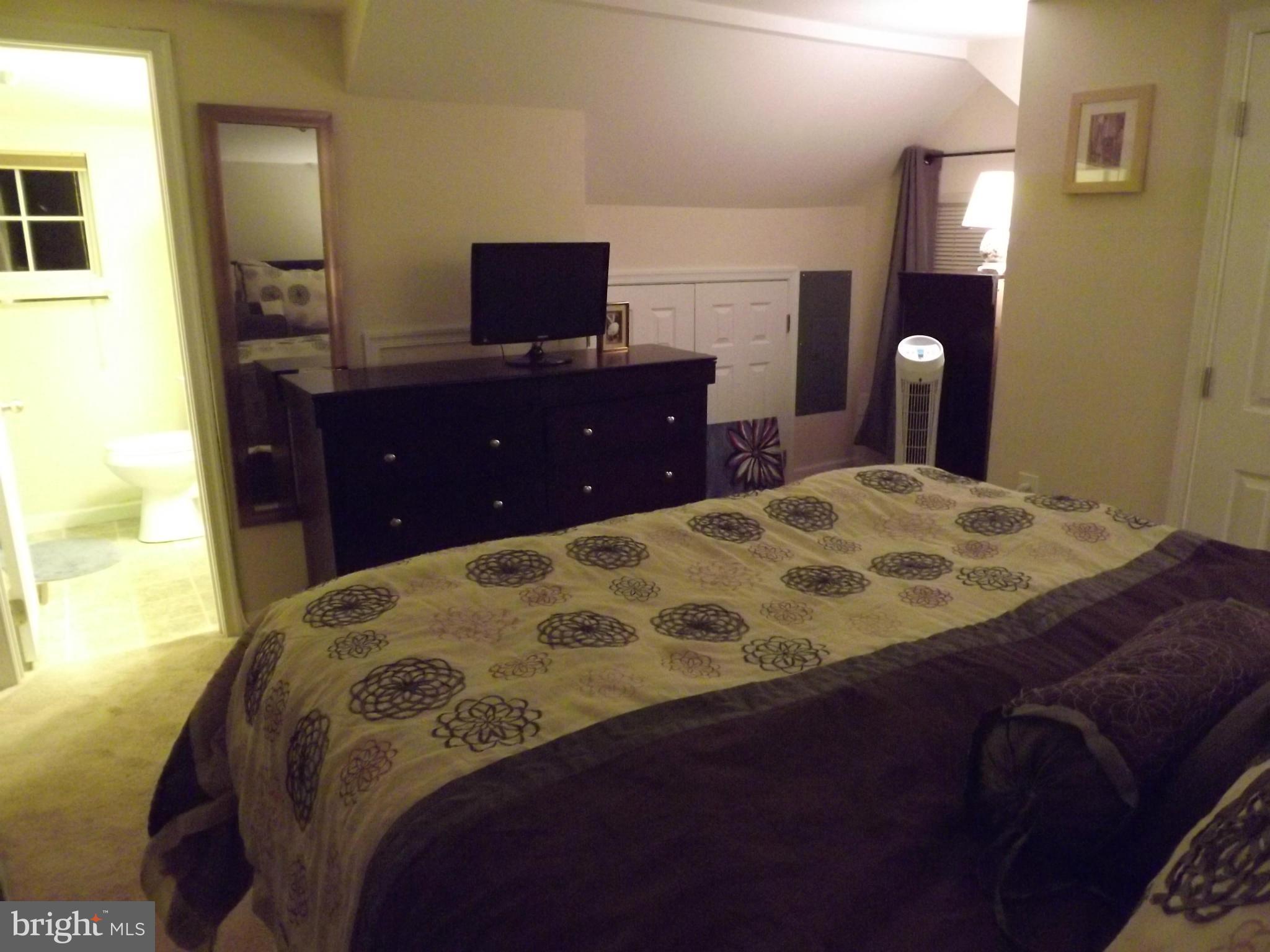 3167 Baybriar Road Baltimore, MD 21222 - Photo 24 of 30 a bedroom with a bed and a flat screen tv