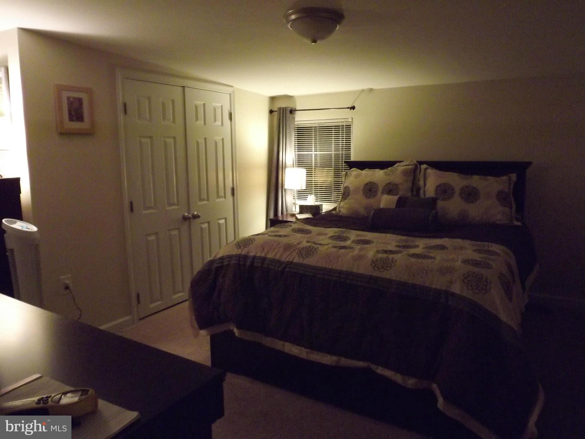 3167 Baybriar Road Baltimore, MD 21222 - Photo 27 of 30 a bedroom with a bed and a night stand