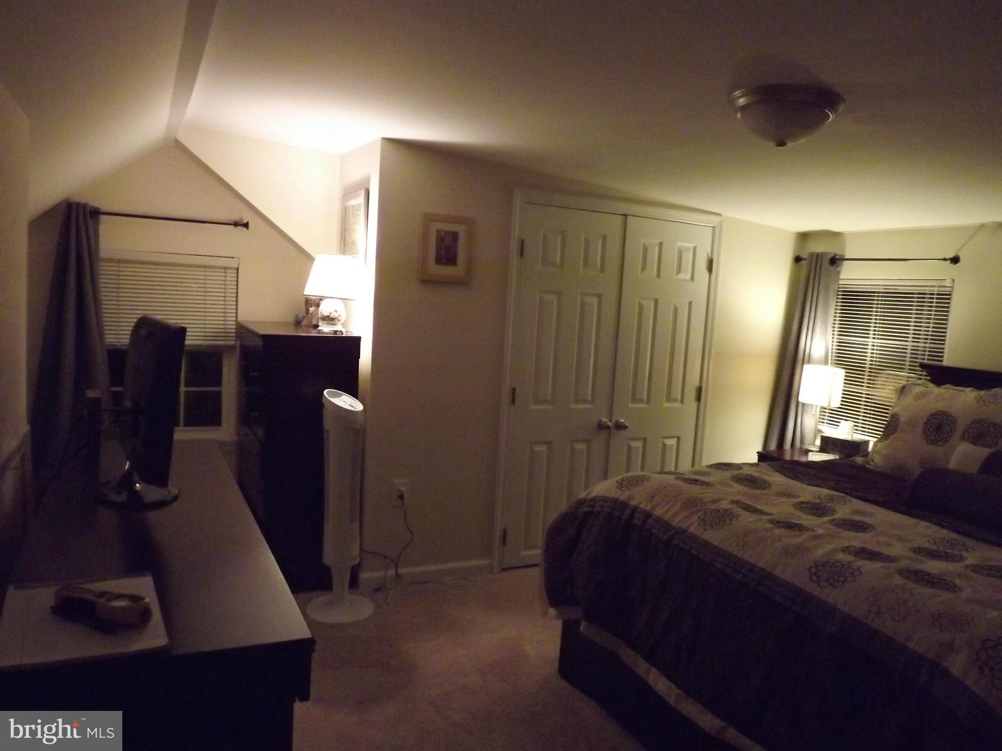 3167 Baybriar Road Baltimore, MD 21222 - Photo 28 of 30 a bedroom with a bed and a mirror
