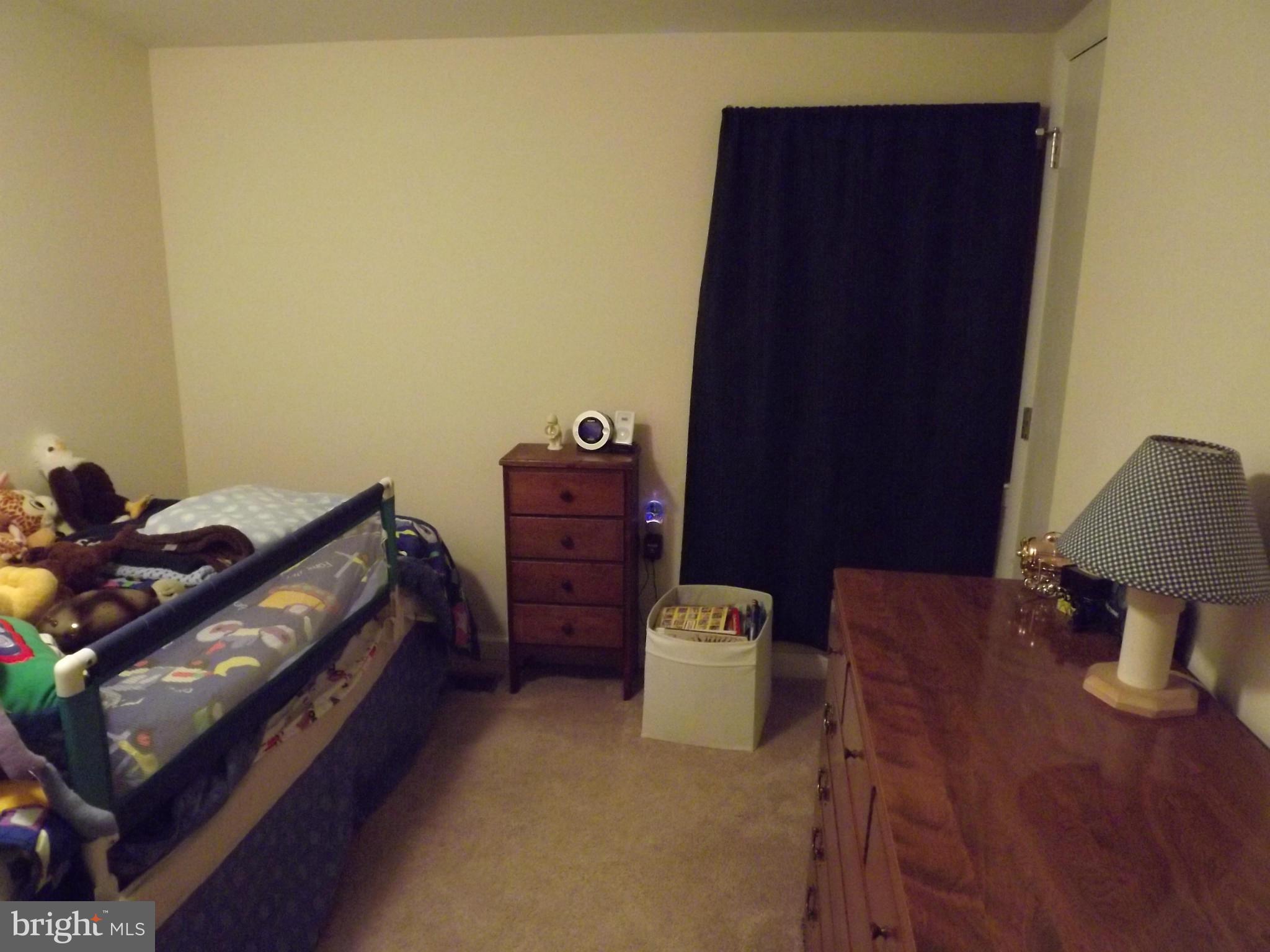 3167 Baybriar Road Baltimore, MD 21222 - Photo 30 of 30 a bedroom with a bed and a lamp on dresser